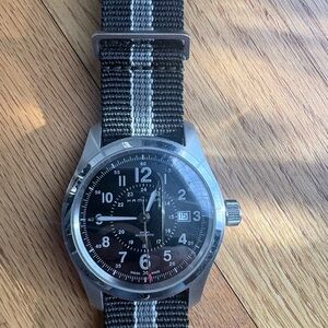 Hamilton Kahki Field Auto Black Dial Watch with Silver Case and Striped Strap.